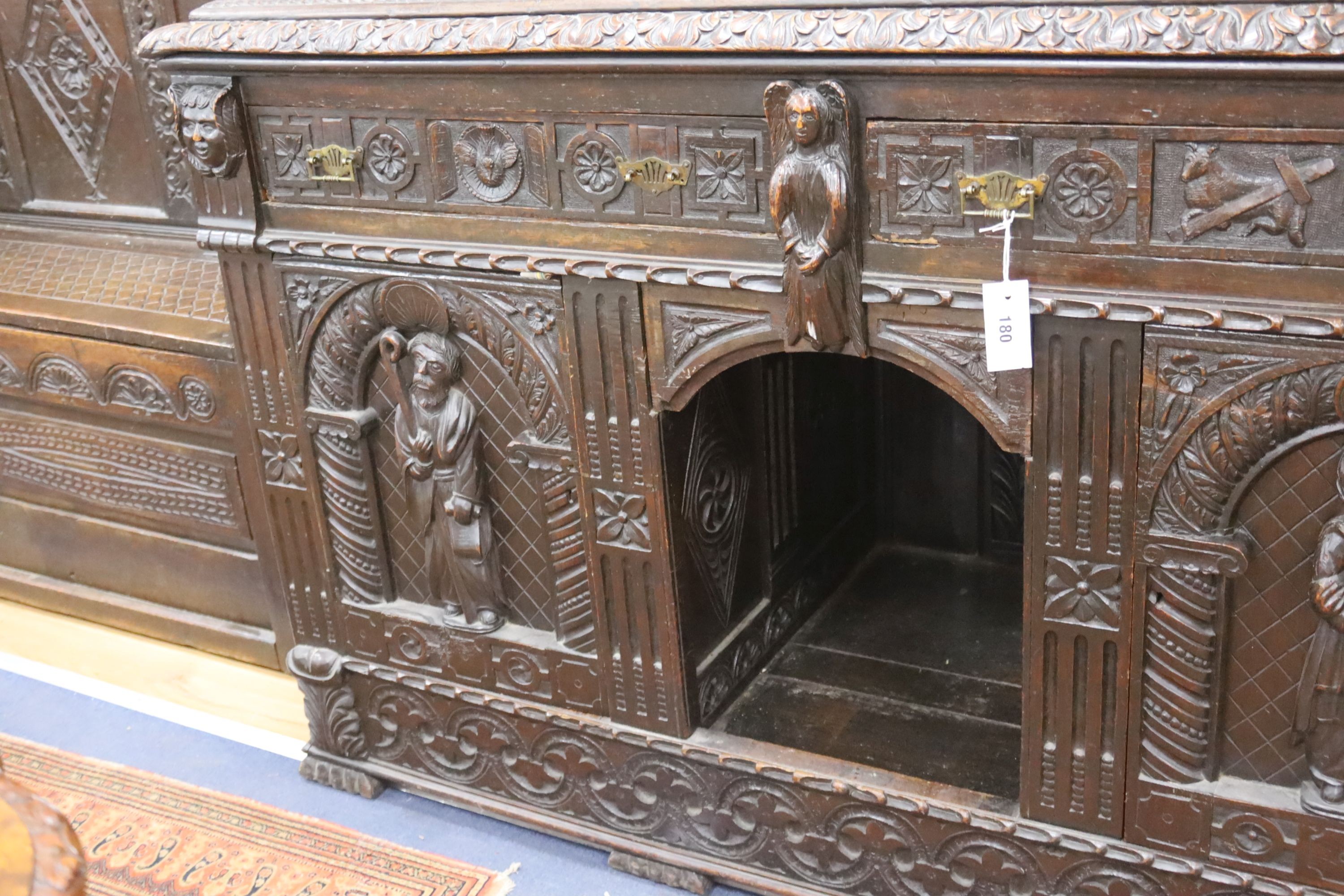 A late 19th century Flemish carved oak sideboard with raised panelled back, width 150, depth 60, height 215 cms.